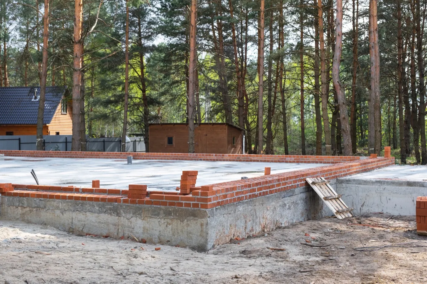 Concrete slab foundation with plumbing pipes rising through it